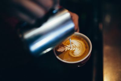 Cropped image of hand preparing coffee
