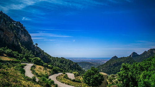 Scenic view of mountains against blue sky