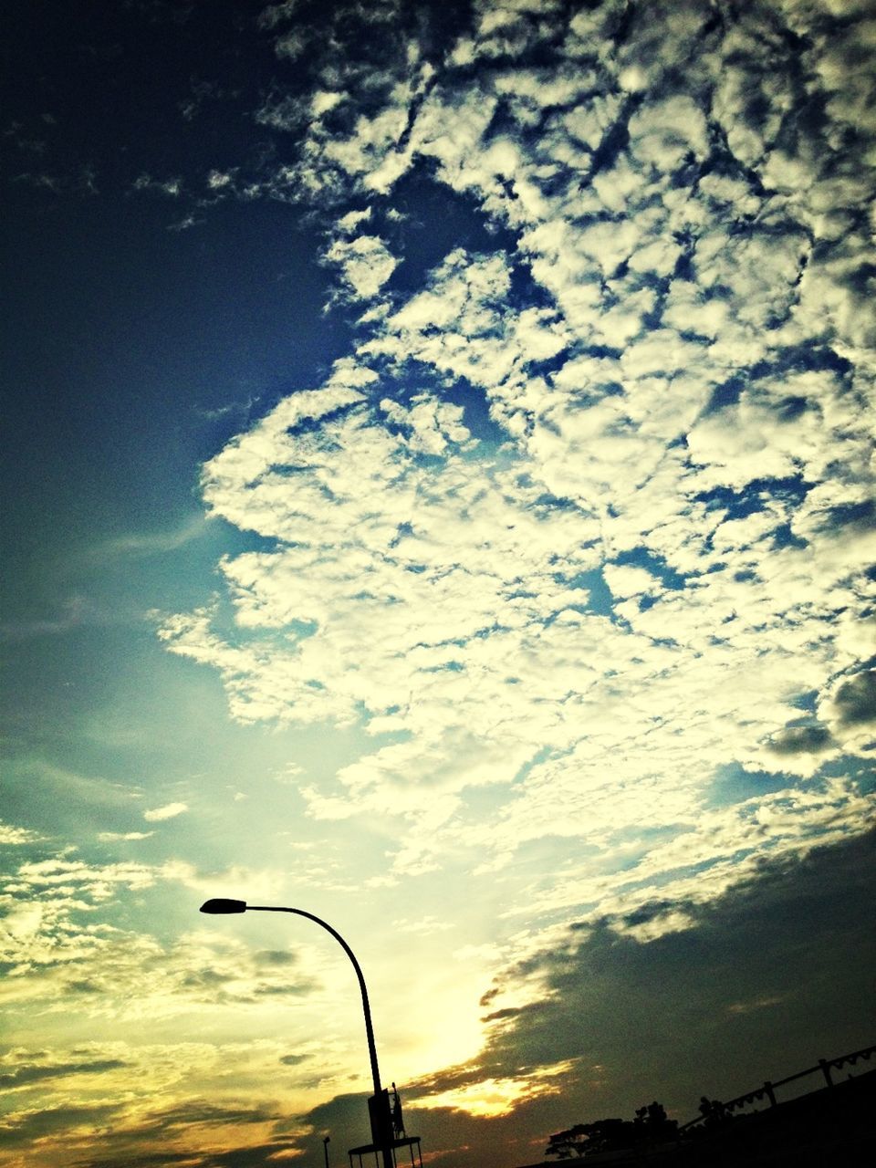 sky, cloud - sky, low angle view, street light, silhouette, sunset, cloudy, nature, beauty in nature, cloud, tranquility, scenics, transportation, tranquil scene, outdoors, no people, lighting equipment, dusk, sunlight, mode of transport