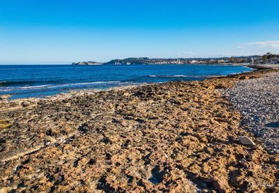 Scenic view of sea against clear blue sky