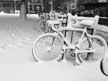 Close-up of snow covered bicycles