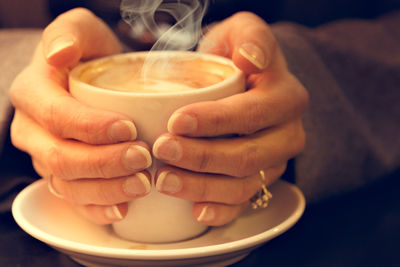 Close-up of hand holding coffee