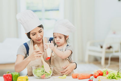 Happy friends preparing food