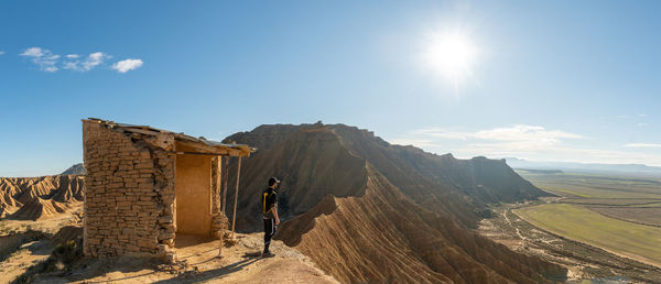 Man standing on mountain against sky