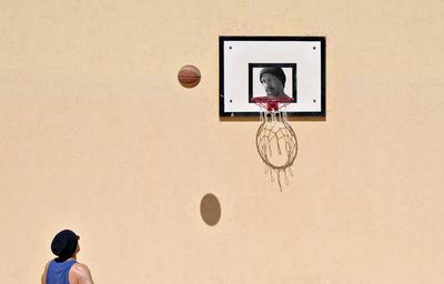 Man playing with basketball hoop