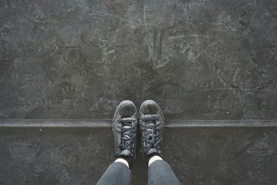 Low section of man standing on ground