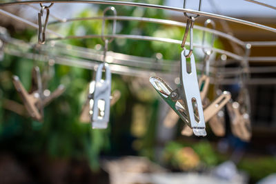 Close-up of clothespins hanging on clothesline