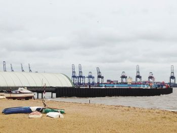 View of harbor against cloudy sky