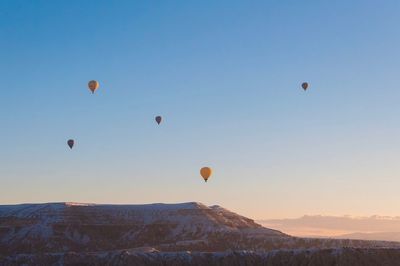 Low angle view of hot air balloons flying in sky