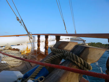 Close-up of rope tied on sailboat against clear sky
