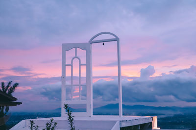 Built structure against dramatic sky during sunset