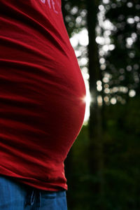 Close-up of woman standing against trees