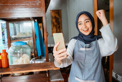 Portrait of young woman using mobile phone