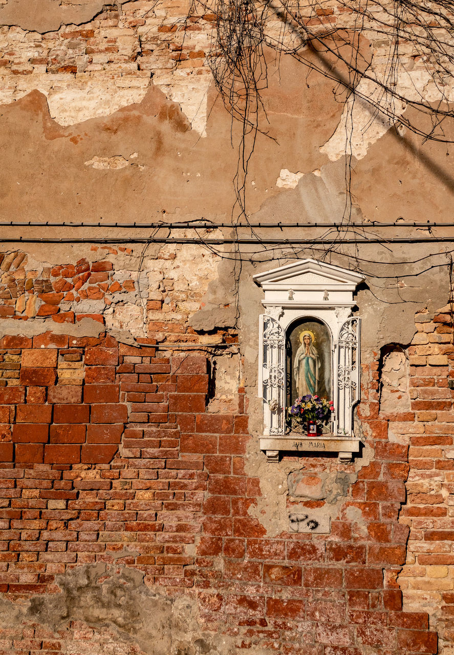 LOW ANGLE VIEW OF STONE WALL WITH WINDOWS