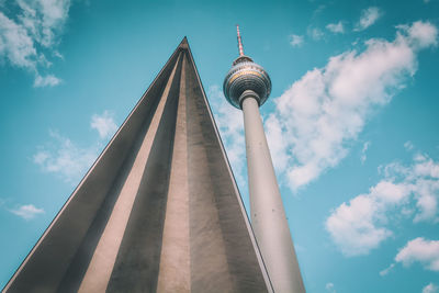Low angle view of fernsehturm by triangle shape against sky