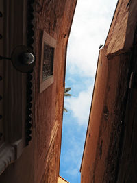 Low angle view of building against cloudy sky