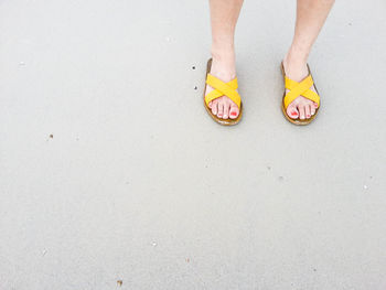 Low section of woman standing on tiled floor