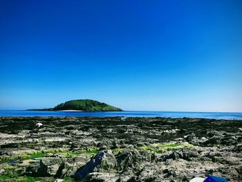 Scenic view of sea against clear blue sky