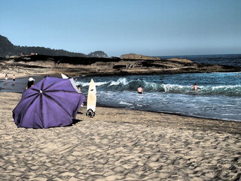 Scenic view of beach against blue sky