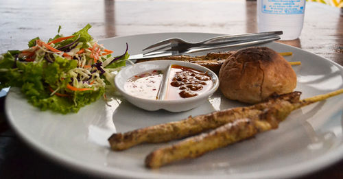 Close-up of chicken satay with bamboo stick on the table in krabi, thailand