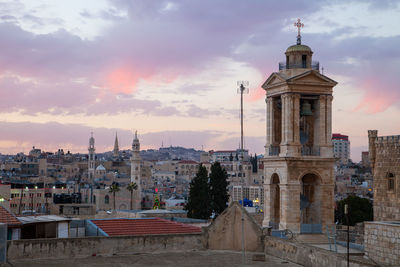 View of buildings in city at sunset