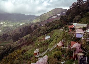 High angle view of townscape by mountain against sky