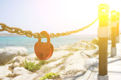 Close-up of padlocks on rope at beach