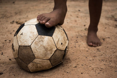 Low section of child playing with ball
