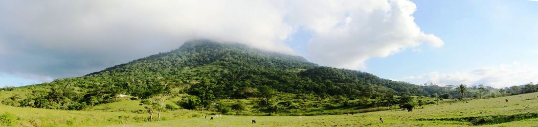 Scenic view of mountains against cloudy sky