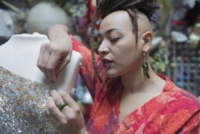 Portrait of stylish young female fashion designer at work