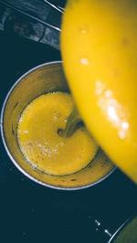 High angle view of juice pouring in glass