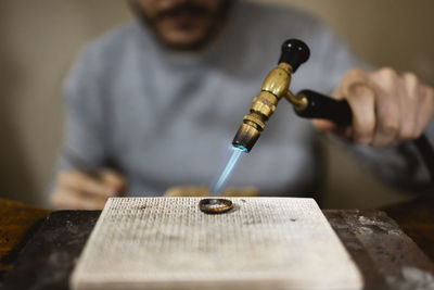 Midsection of man working on wood