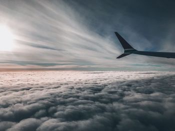 Airplane flying over cloudscape against sky