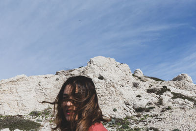 Portrait of woman against rock