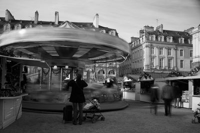 Blurred motion of people and ride in city