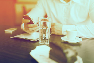 Midsection of coffee cup on table