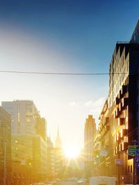 Modern buildings against sky during sunset