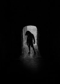 Full length of silhouette man in tunnel