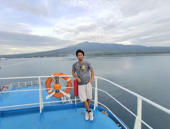 Full length of man on railing against sea