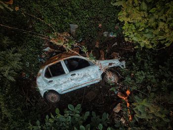 High angle view of abandoned car on field