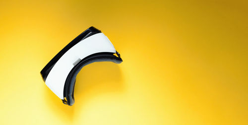 High angle view of illuminated lamp against yellow background