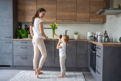 Side view of young woman standing on floor