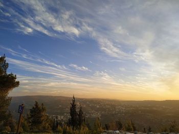 Scenic view of city against sky during sunset