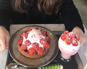 High angle view of ice cream with strawberries in container