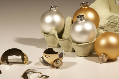 Close-up of broken baubles on white background