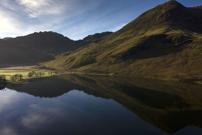 Scenic view of lake and mountains against sky