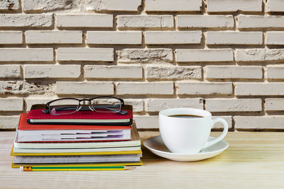 Coffee cup on table against wall