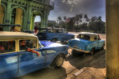 Cars on road against blue sky