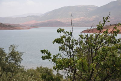Scenic view of sea and mountains against sky