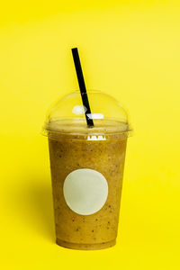 Close-up of drink against yellow background